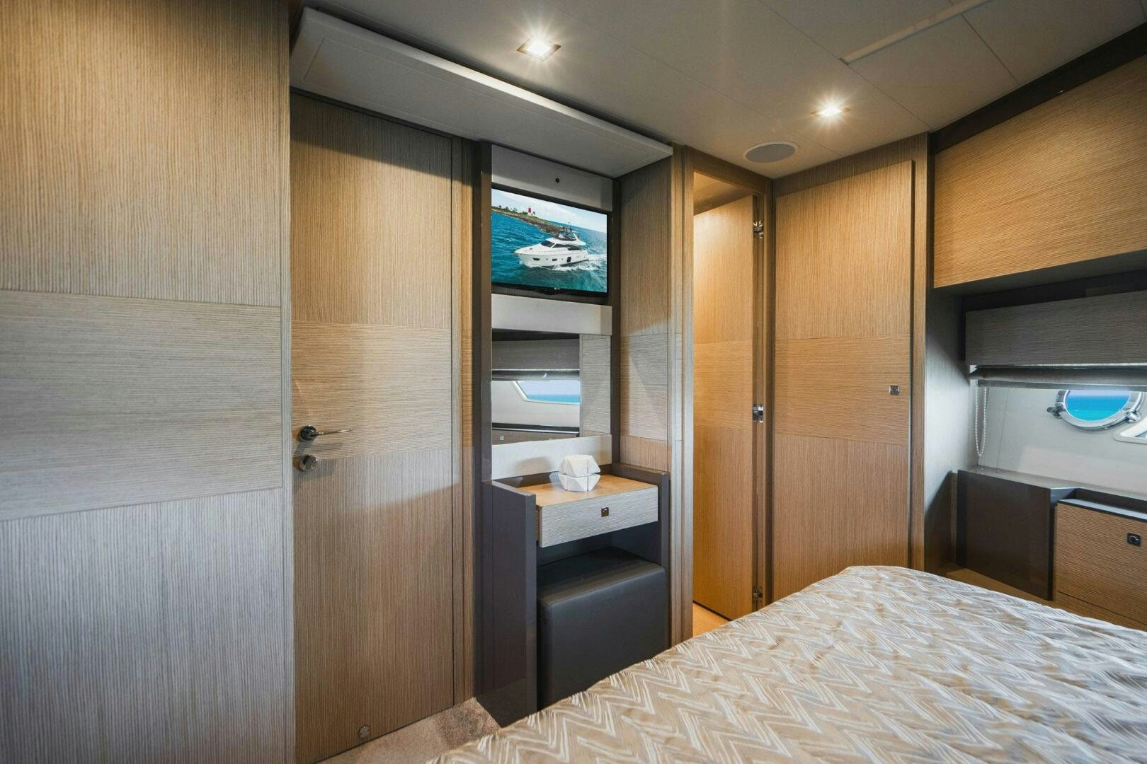 a bedroom with a bed and a closet aboard KUDU Yacht for Sale