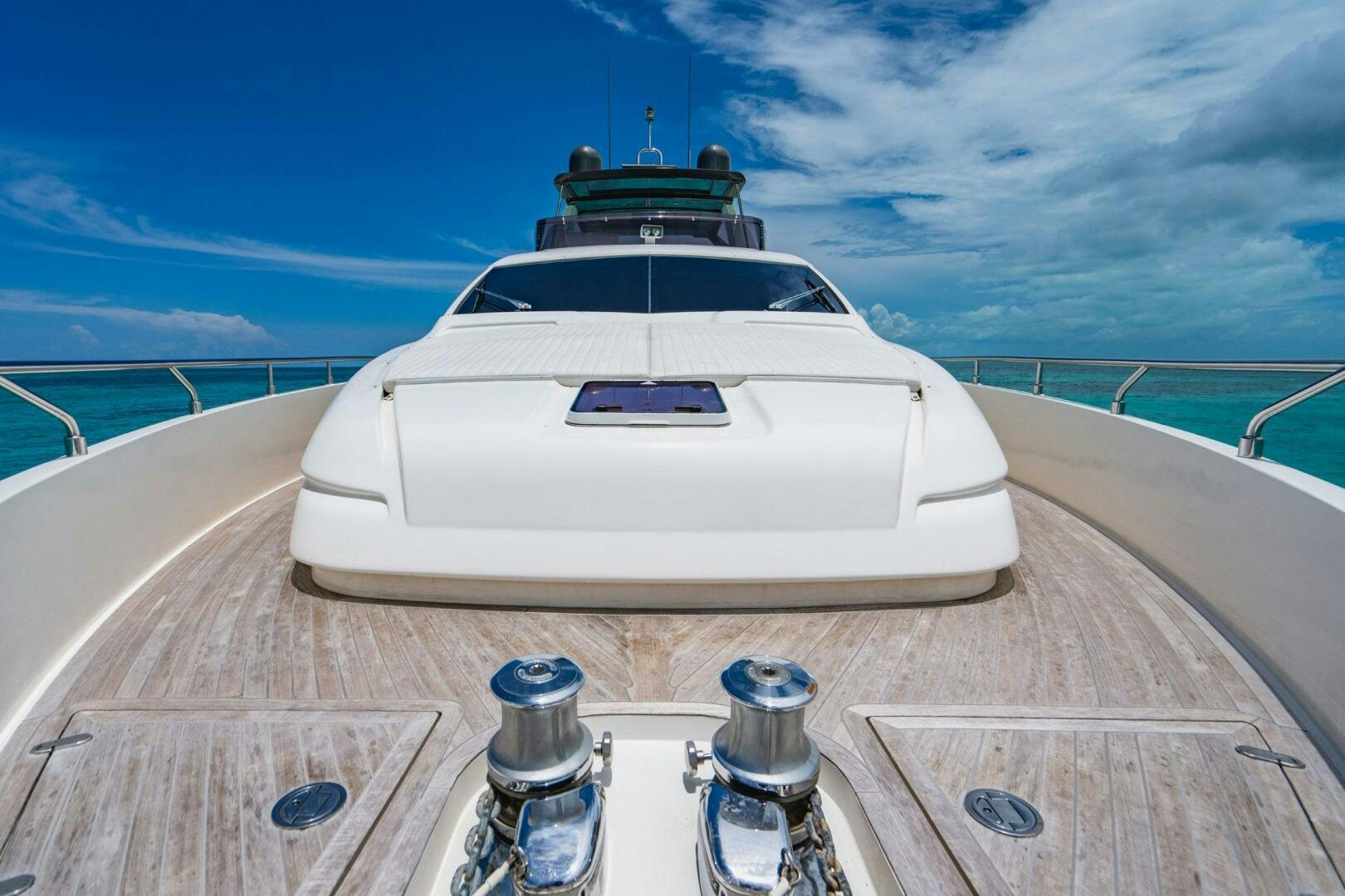 a white car on a wooden deck aboard KUDU Yacht for Sale