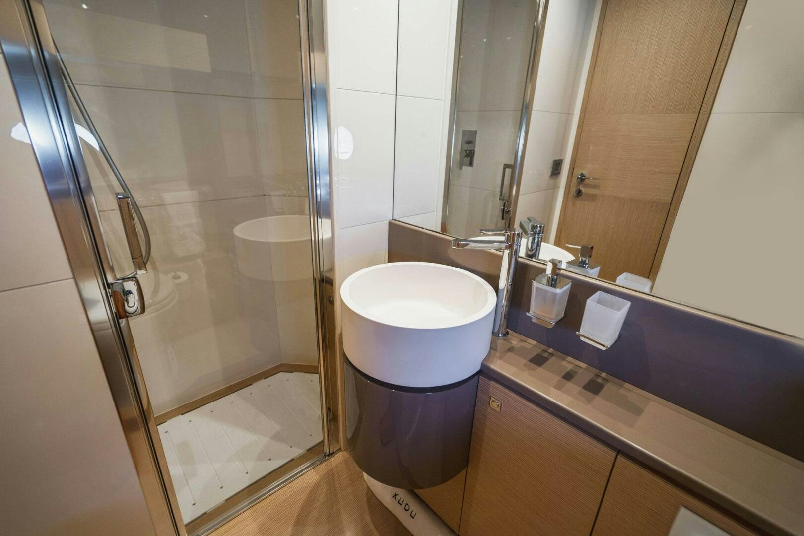 a bathroom with a glass shower aboard KUDU Yacht for Sale