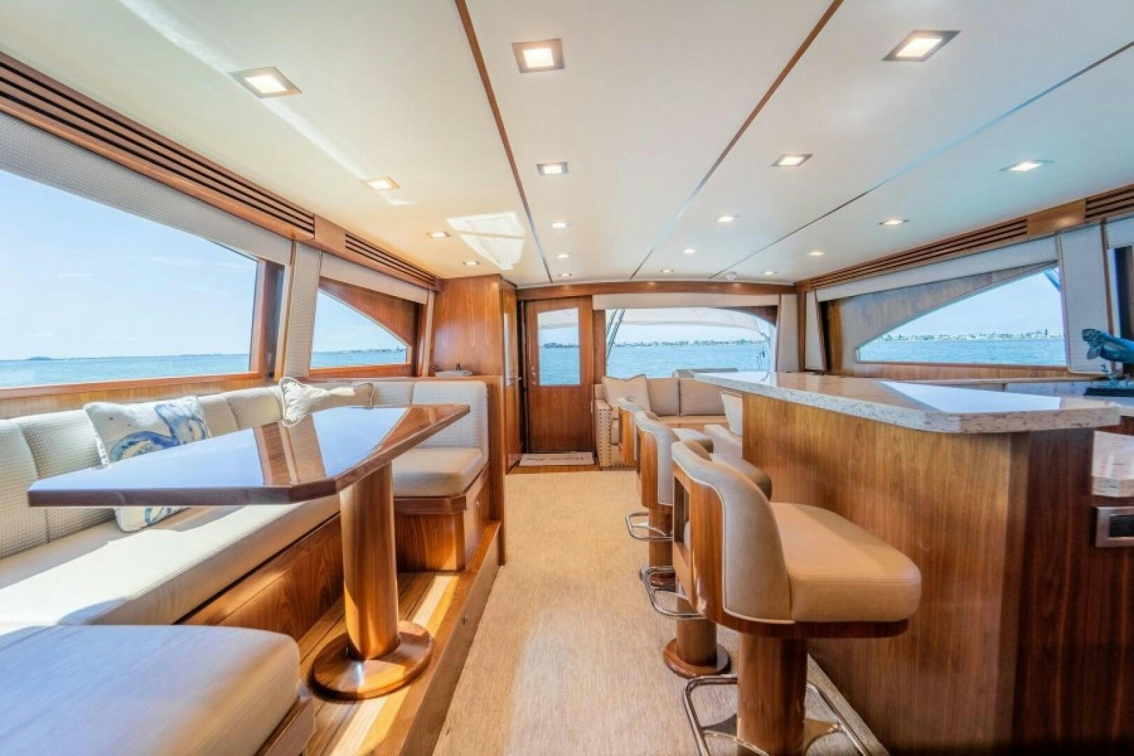 a room with a couch and a table and chairs aboard WRAPPED UP Yacht for Sale