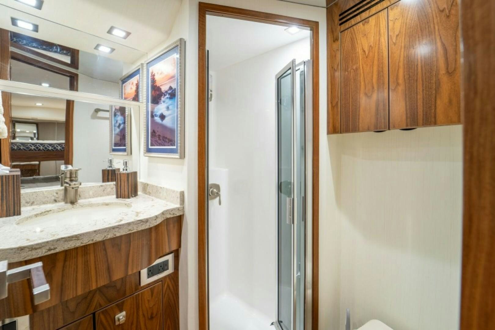 a bathroom with a sink and a mirror aboard WRAPPED UP Yacht for Sale