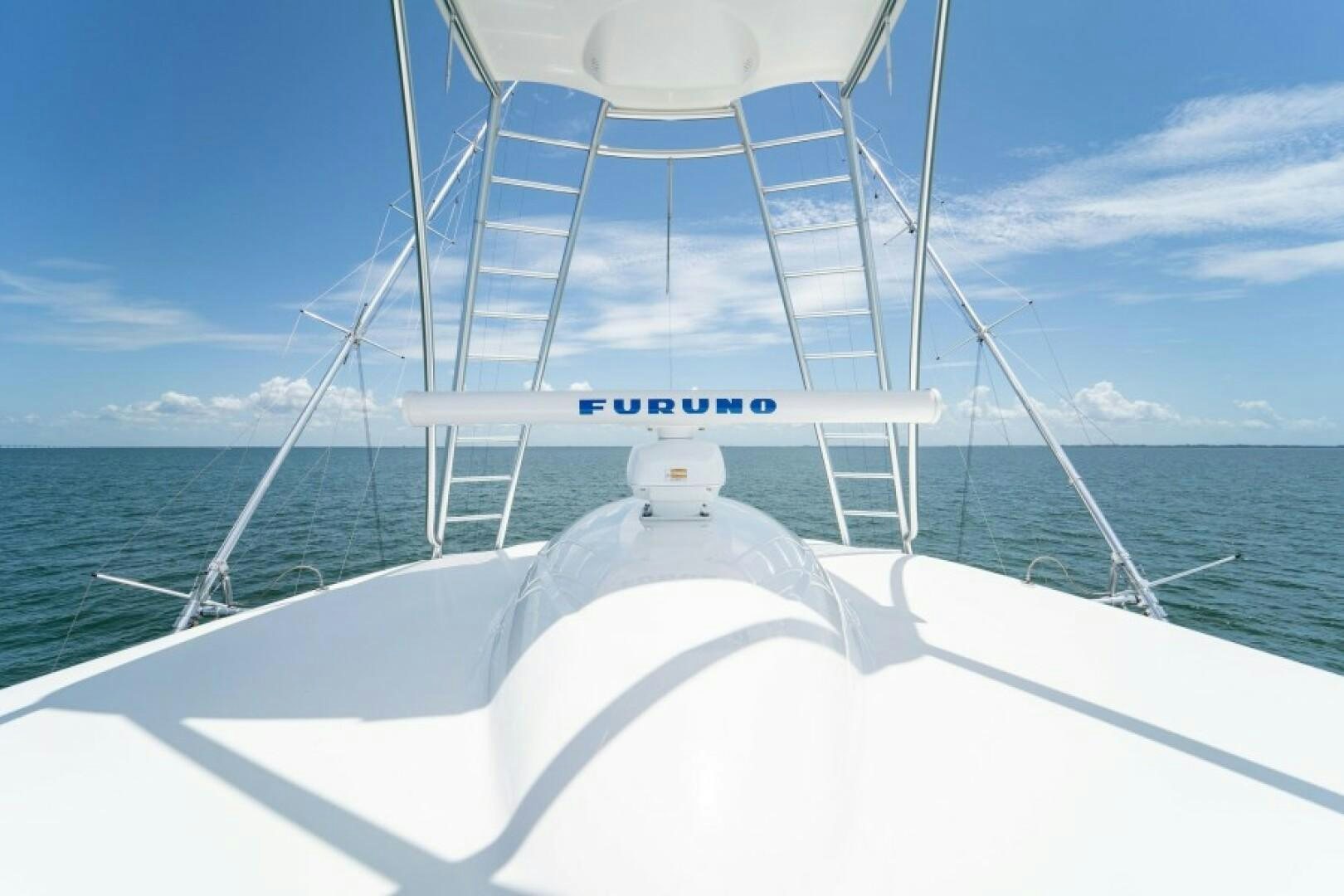 a white boat on the water aboard WRAPPED UP Yacht for Sale