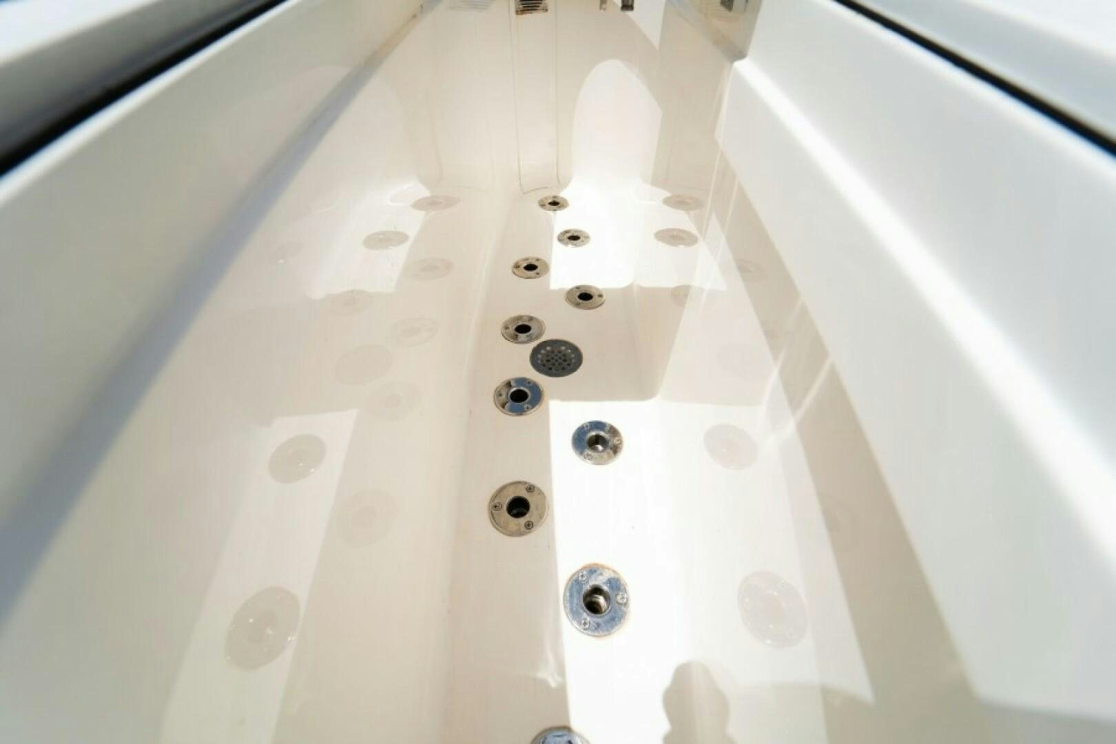 a close-up of a white car's wheel aboard WRAPPED UP Yacht for Sale