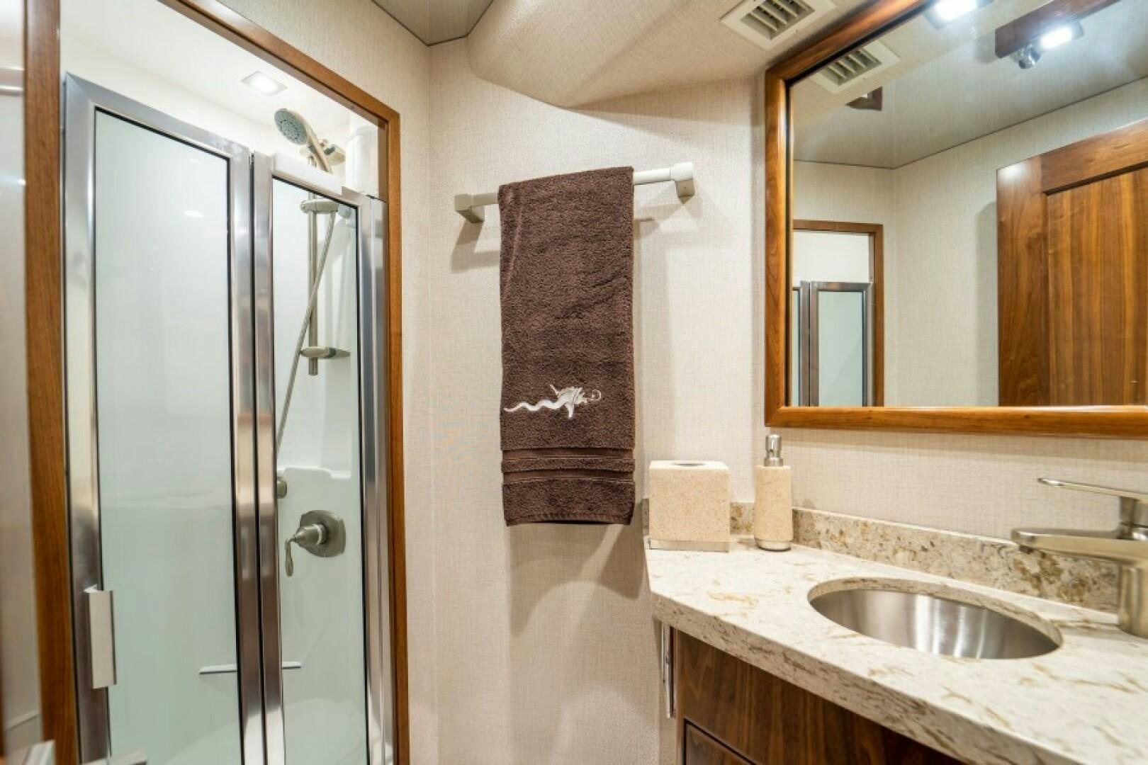 a bathroom with a sink and a mirror aboard WRAPPED UP Yacht for Sale