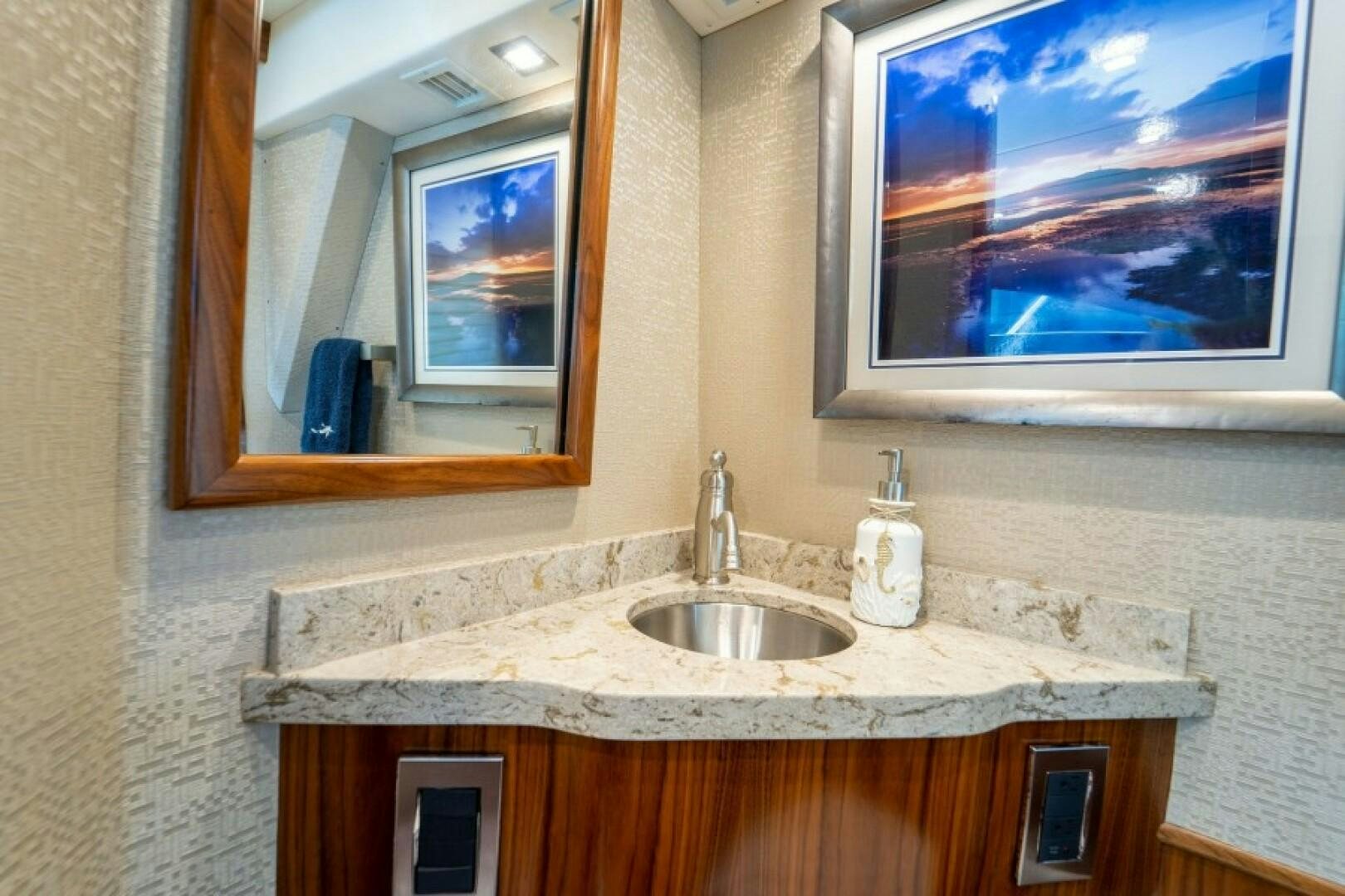 a bathroom with a sink and a mirror aboard WRAPPED UP Yacht for Sale