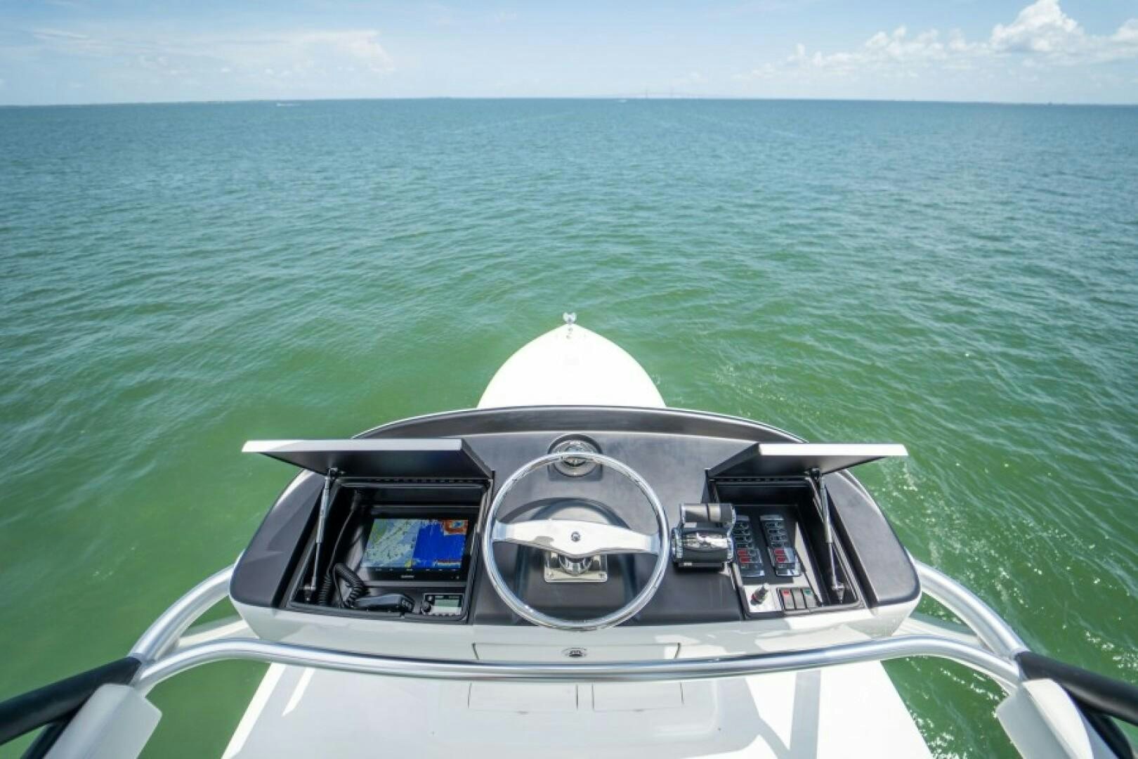 a car driving on the water aboard WRAPPED UP Yacht for Sale