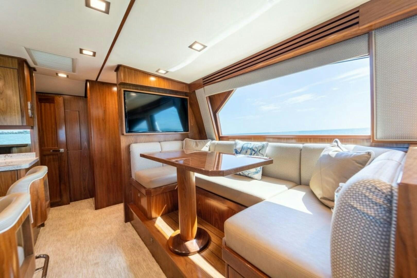 a living room with a couch and a table aboard WRAPPED UP Yacht for Sale