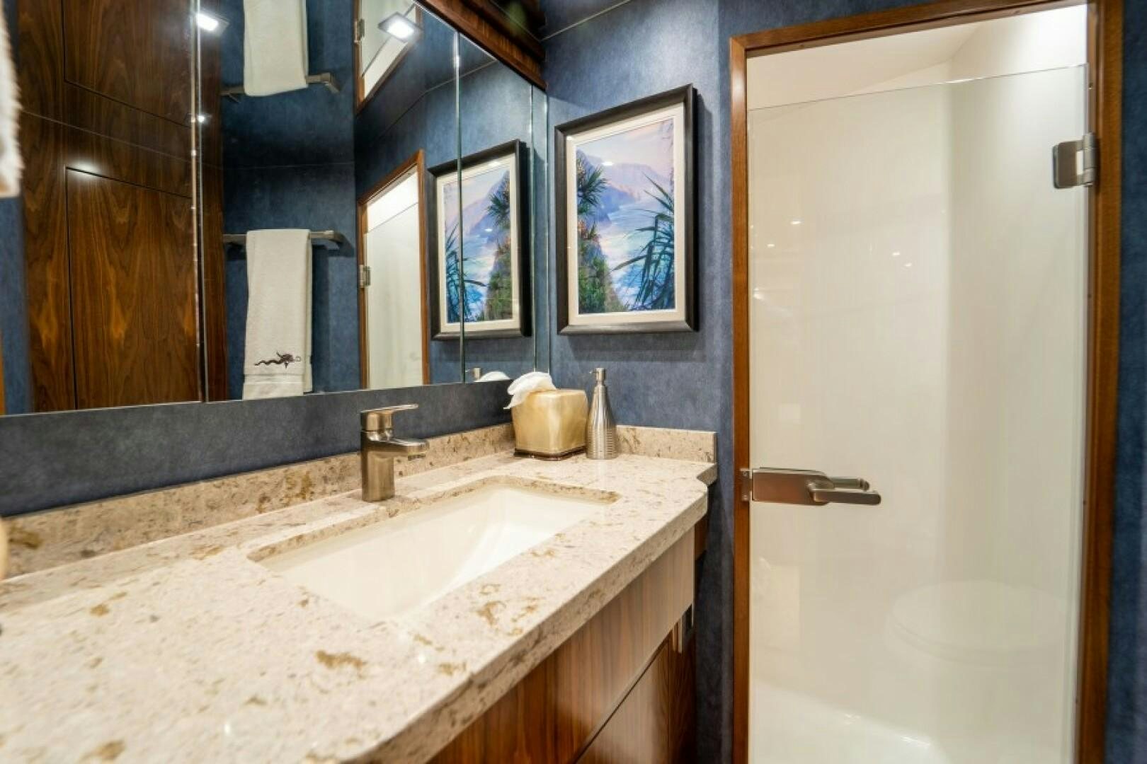 a bathroom with a sink and a mirror aboard WRAPPED UP Yacht for Sale
