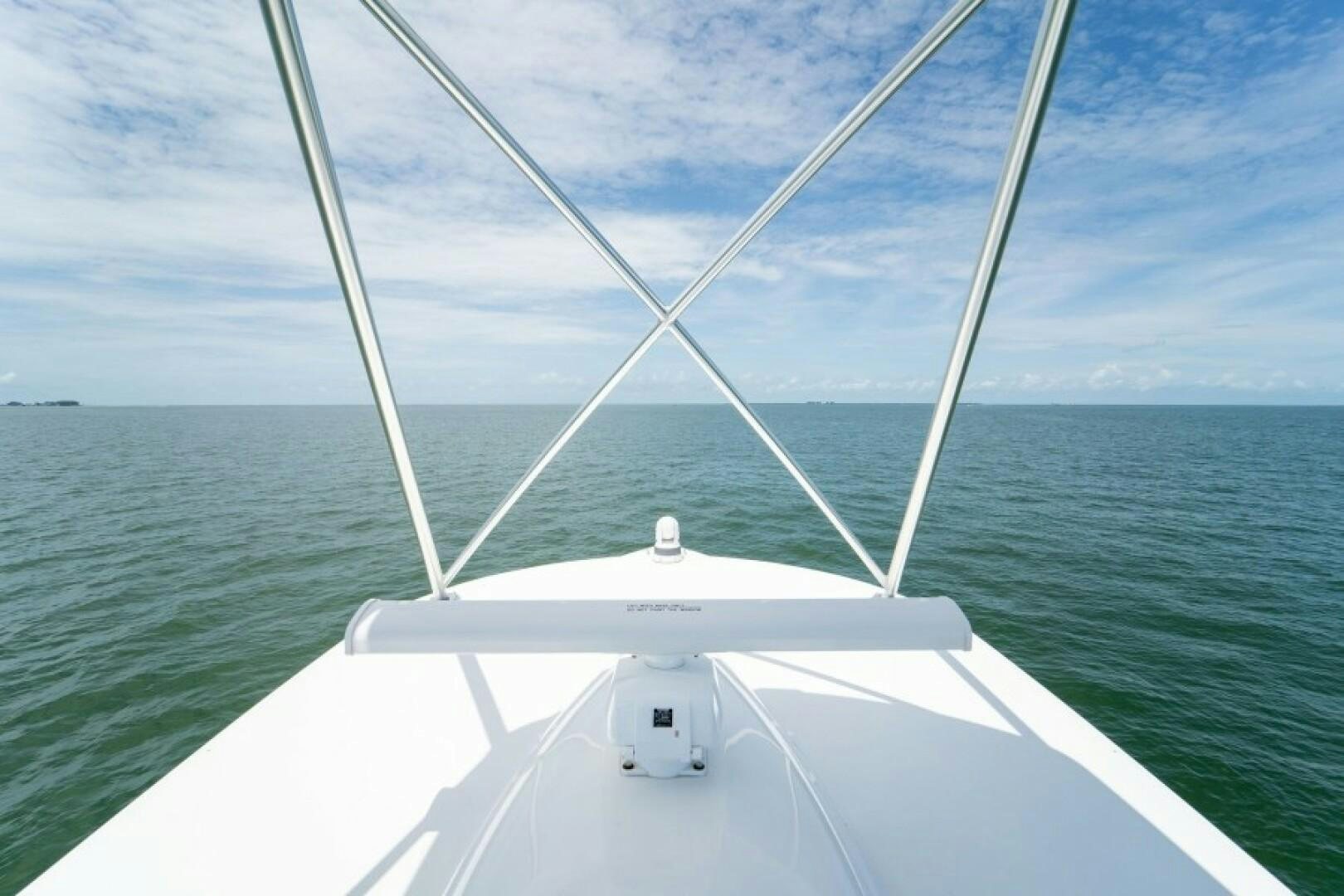 a white boat on the water aboard WRAPPED UP Yacht for Sale