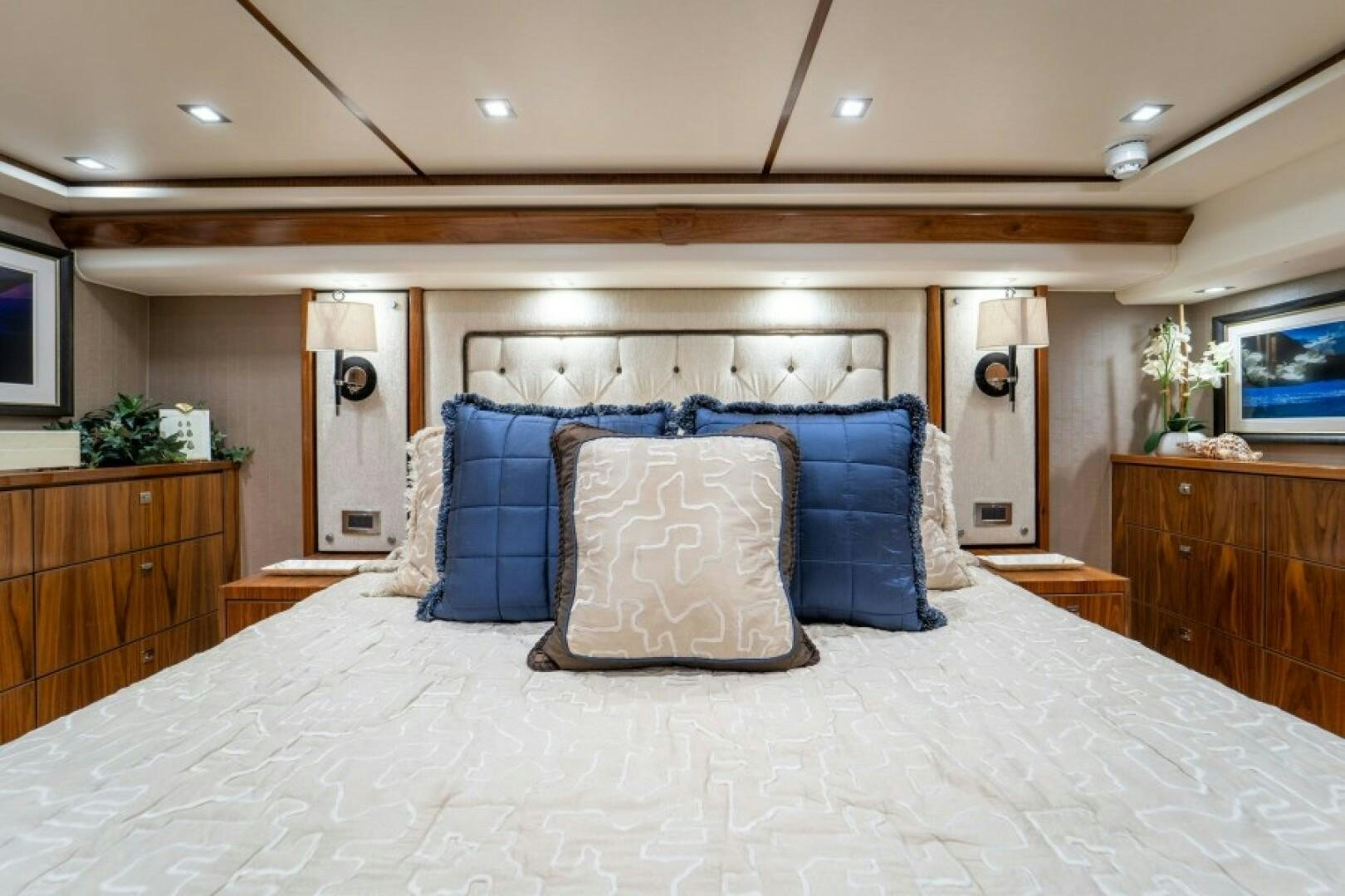 a bed with blue pillows aboard WRAPPED UP Yacht for Sale