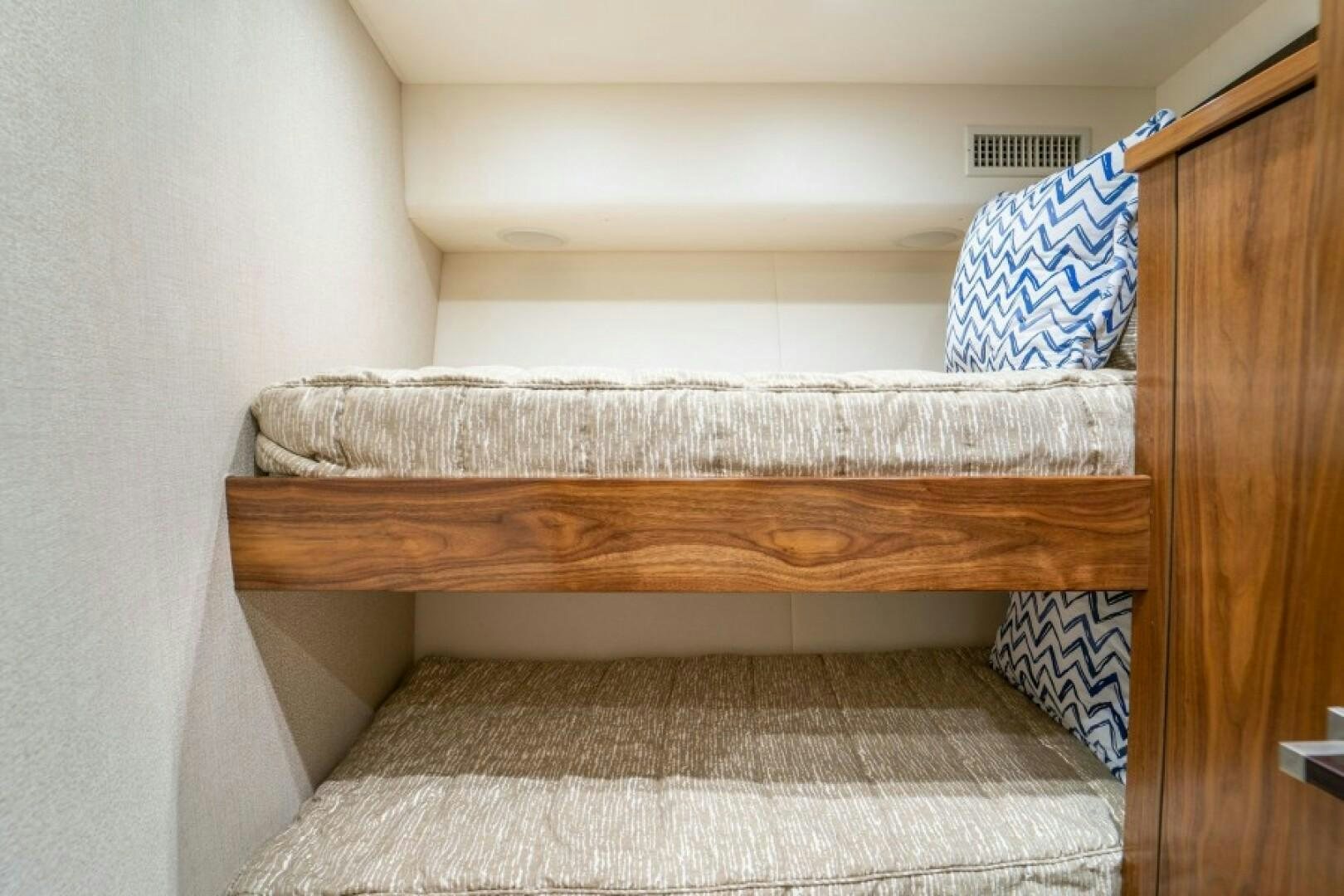 a bed with a wooden frame aboard WRAPPED UP Yacht for Sale