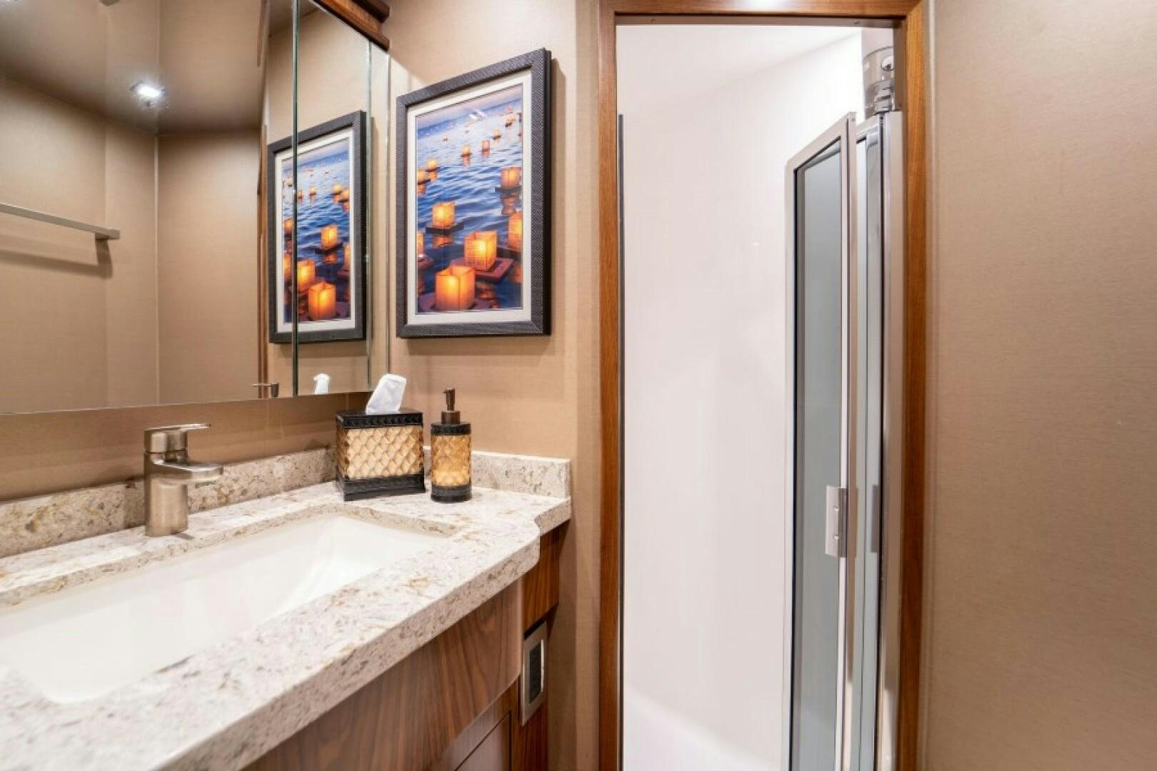 a bathroom with a sink and a mirror aboard WRAPPED UP Yacht for Sale