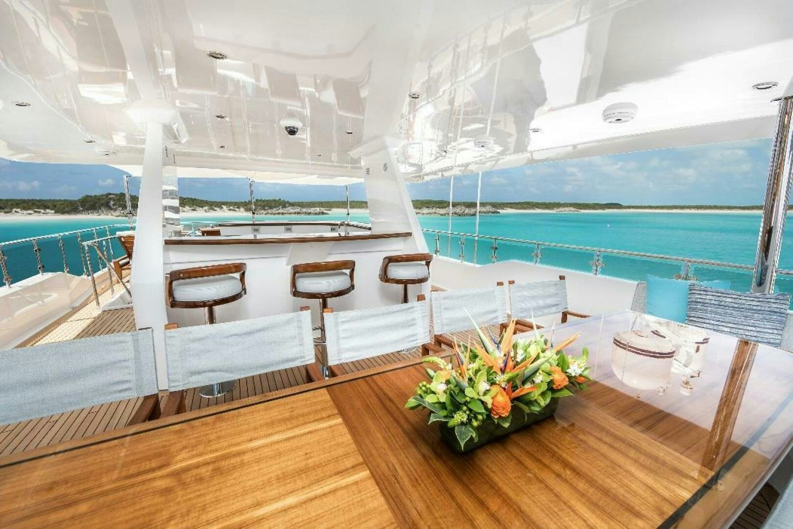a room with a table and chairs aboard MEMENTO VIVERE Yacht for Sale