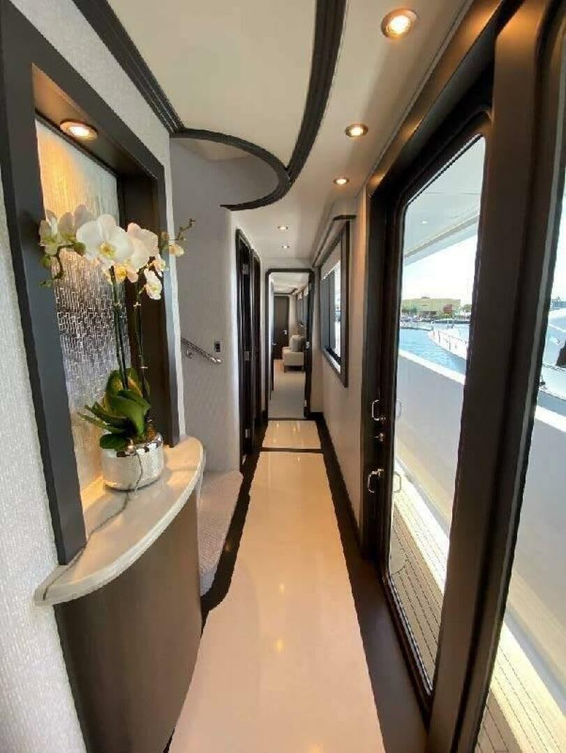 a hallway with a glass door aboard MEMENTO VIVERE Yacht for Sale