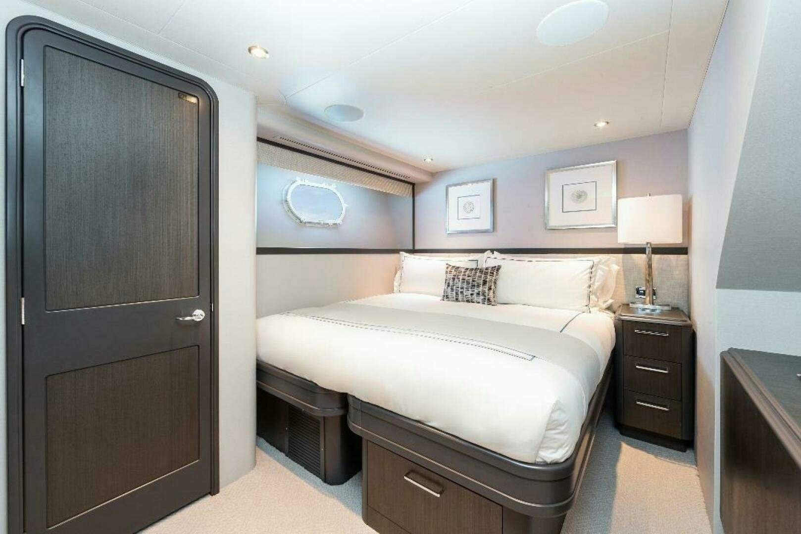 a bedroom with a bed and a closet aboard MEMENTO VIVERE Yacht for Sale
