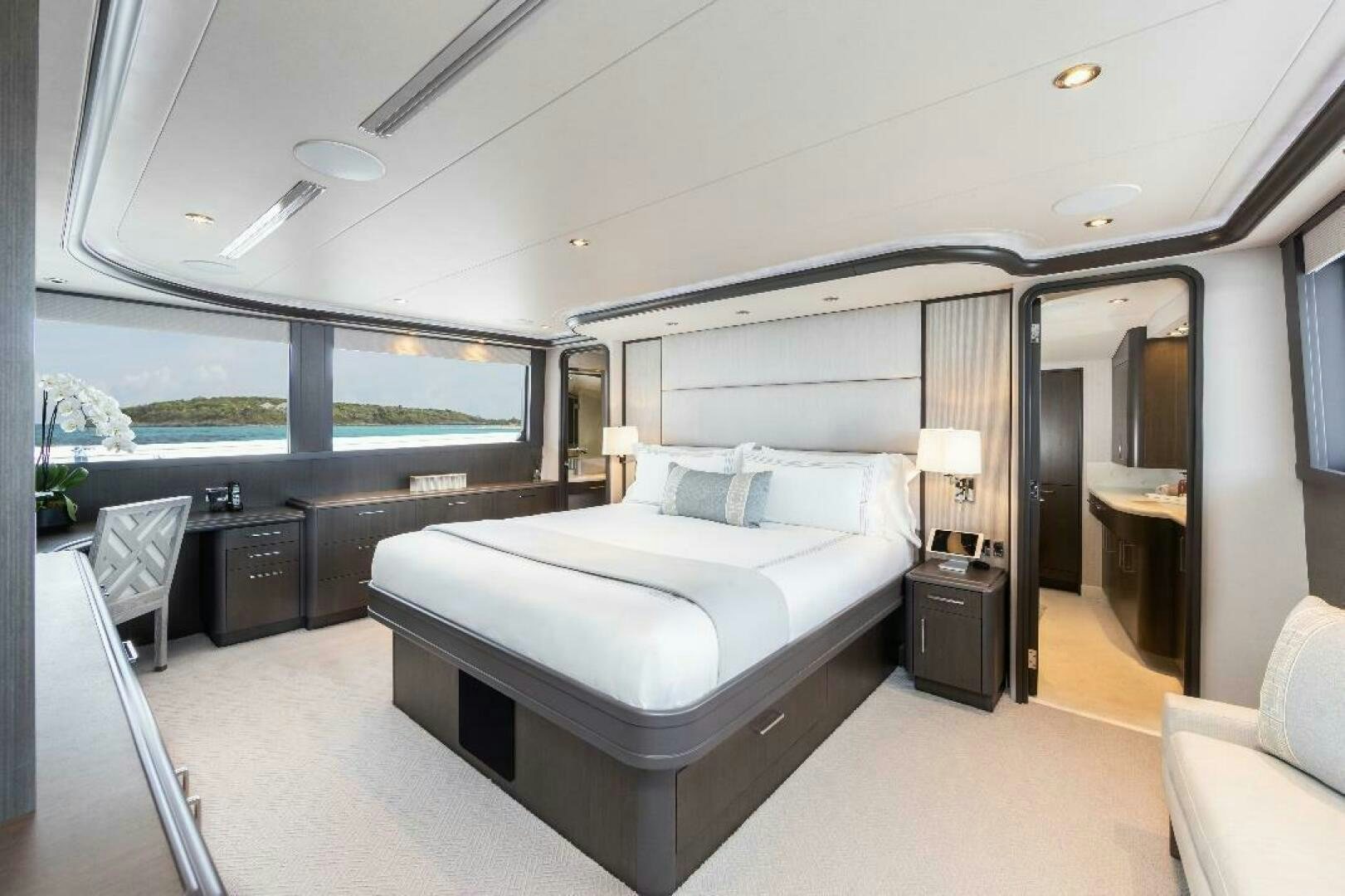 a room with a bed and a large window aboard MEMENTO VIVERE Yacht for Sale