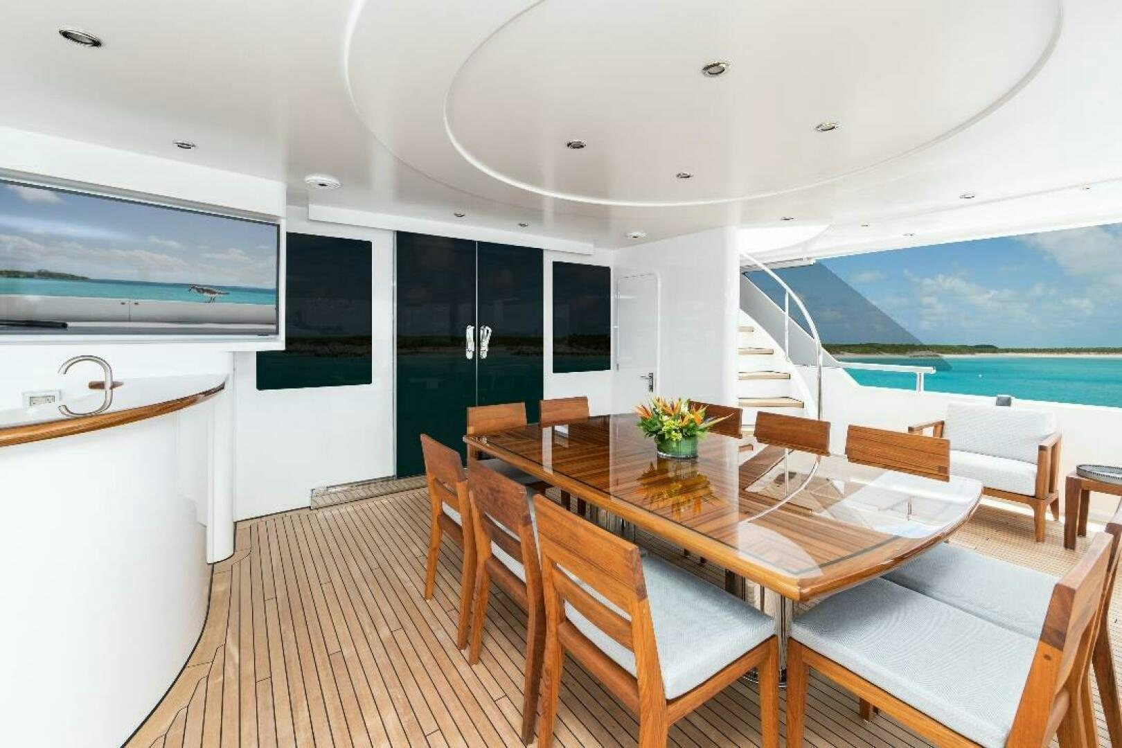 a room with a table and chairs aboard MEMENTO VIVERE Yacht for Sale