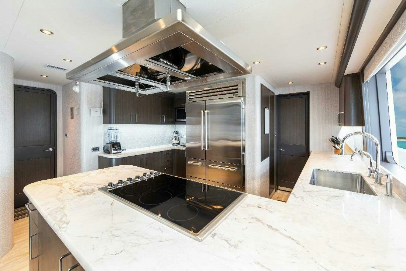 a kitchen with a large island aboard MEMENTO VIVERE Yacht for Sale