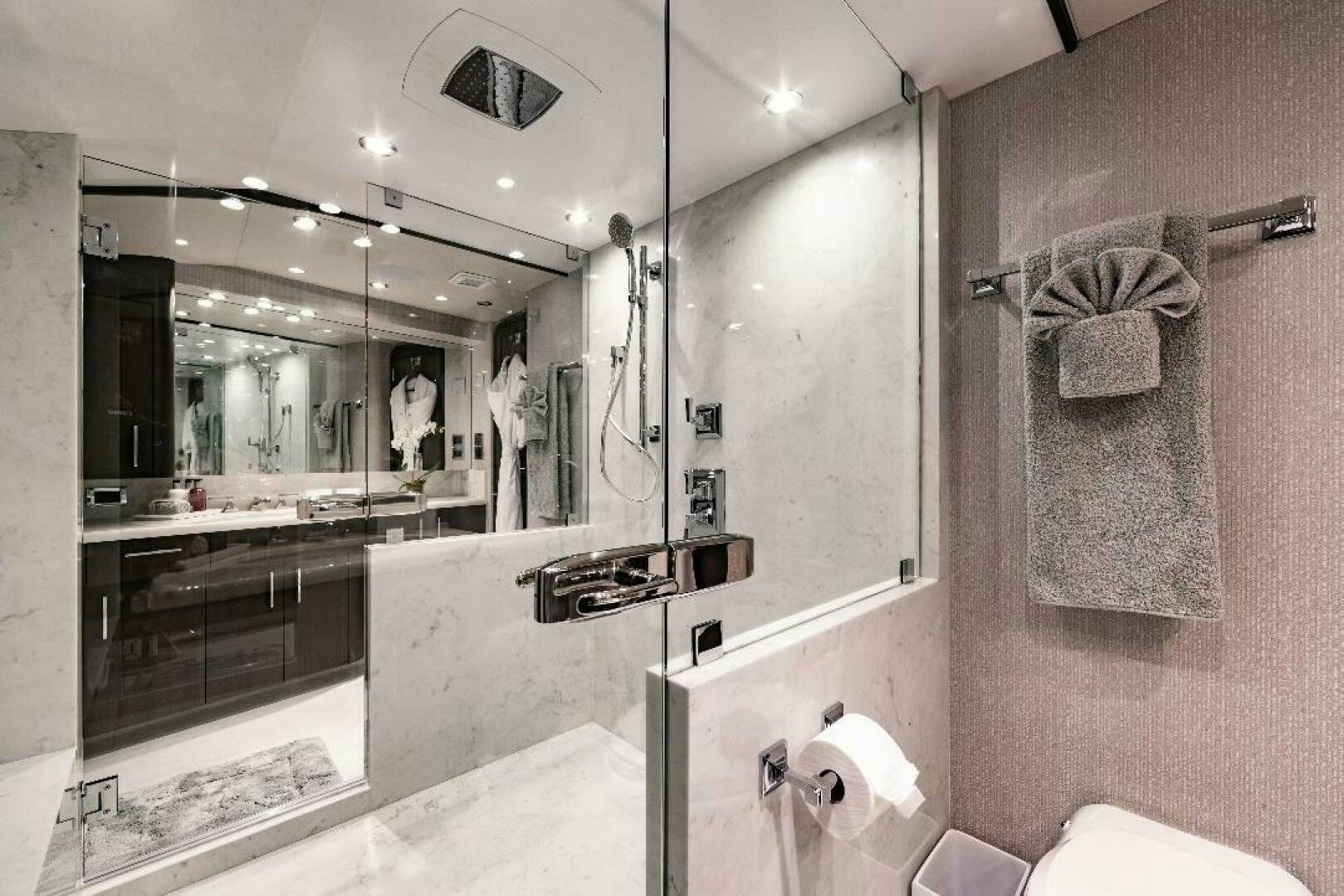 a bathroom with a large mirror aboard MEMENTO VIVERE Yacht for Sale