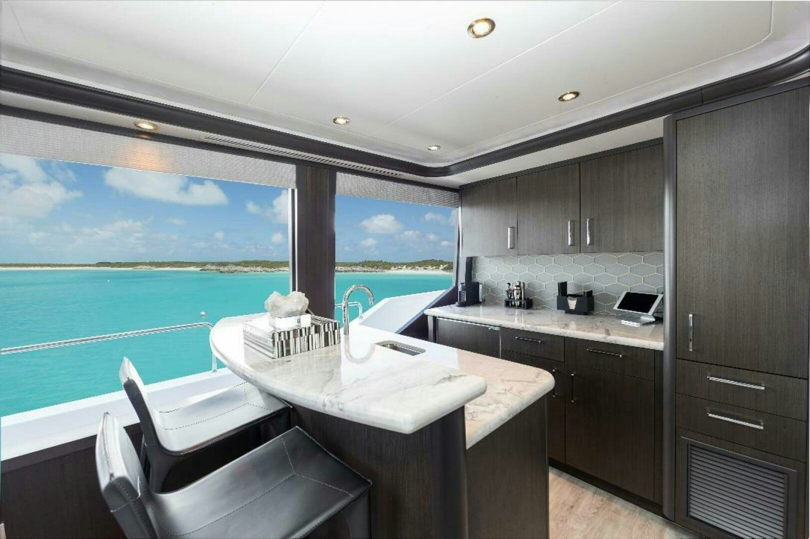 a kitchen with a large window aboard MEMENTO VIVERE Yacht for Sale