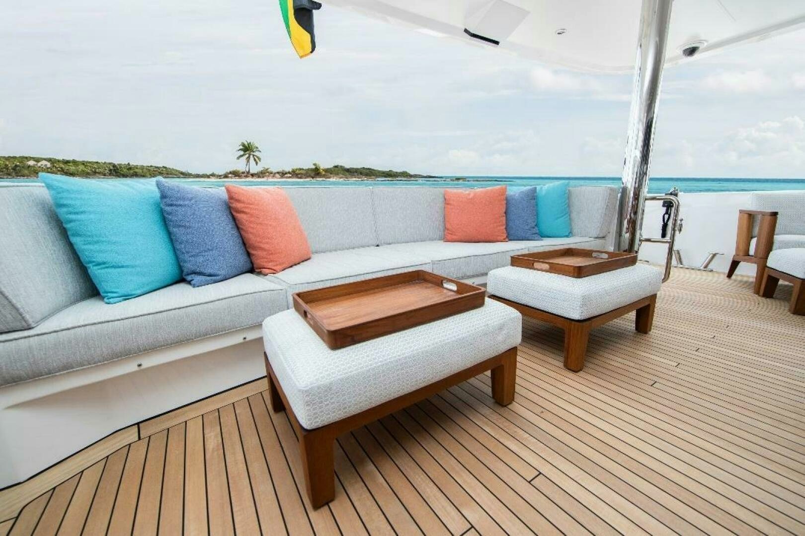 a couch and chairs on a deck aboard MEMENTO VIVERE Yacht for Sale