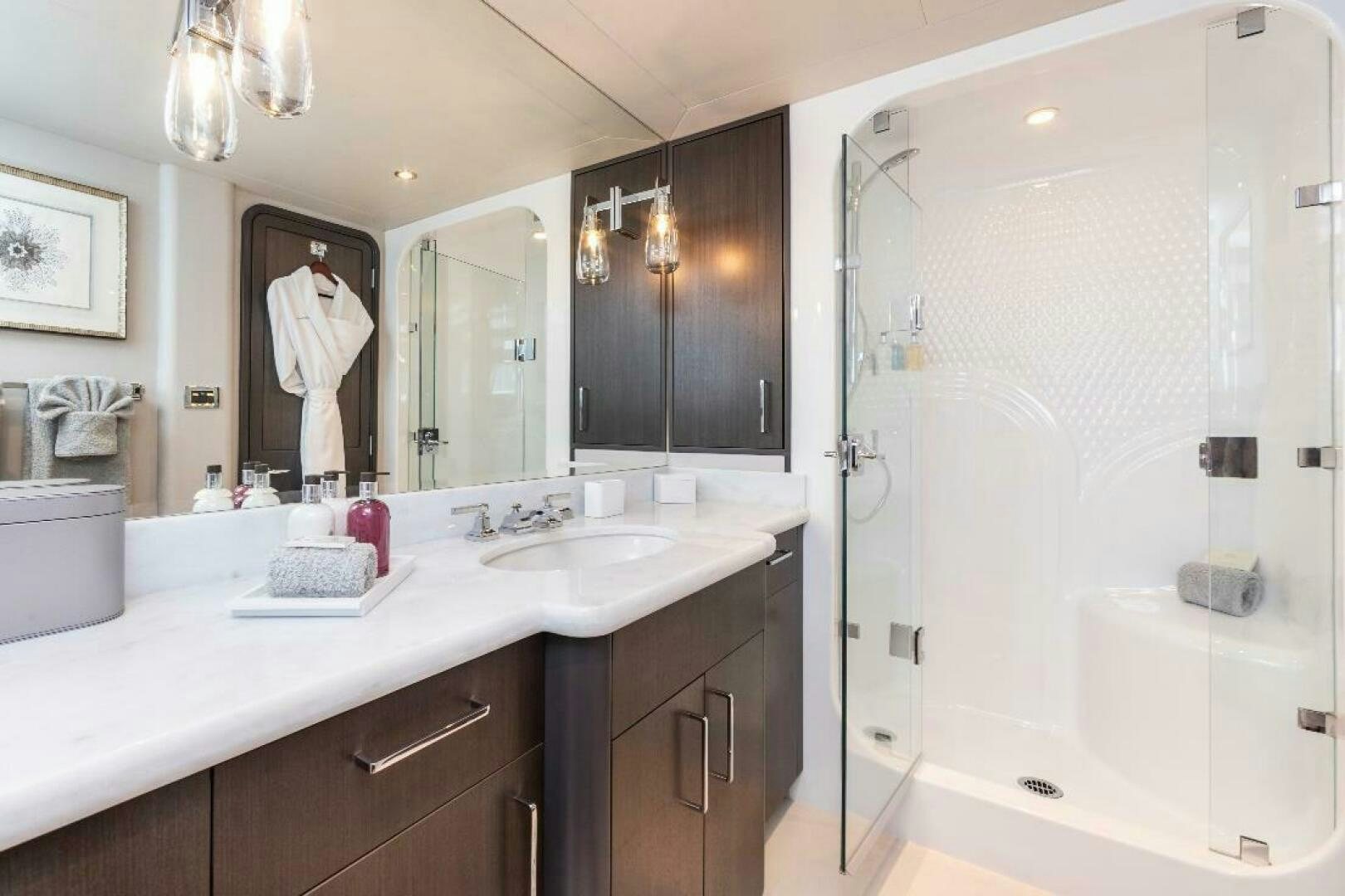 a bathroom with a large mirror aboard MEMENTO VIVERE Yacht for Sale