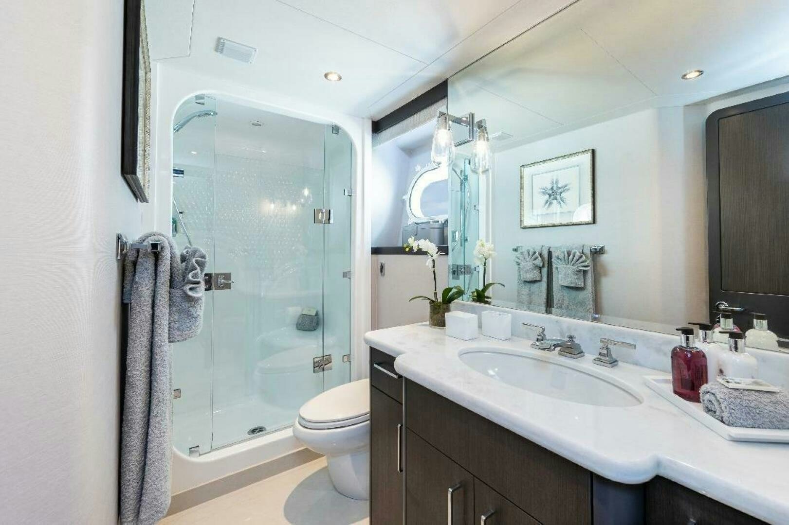 a bathroom with a glass shower aboard MEMENTO VIVERE Yacht for Sale