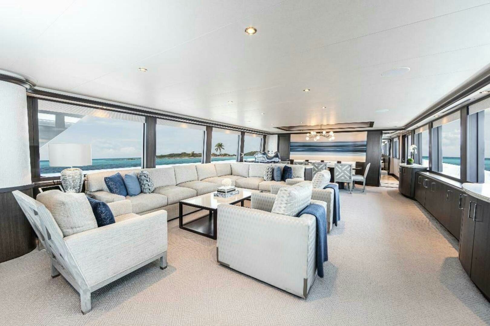 a living room with a large window aboard MEMENTO VIVERE Yacht for Sale