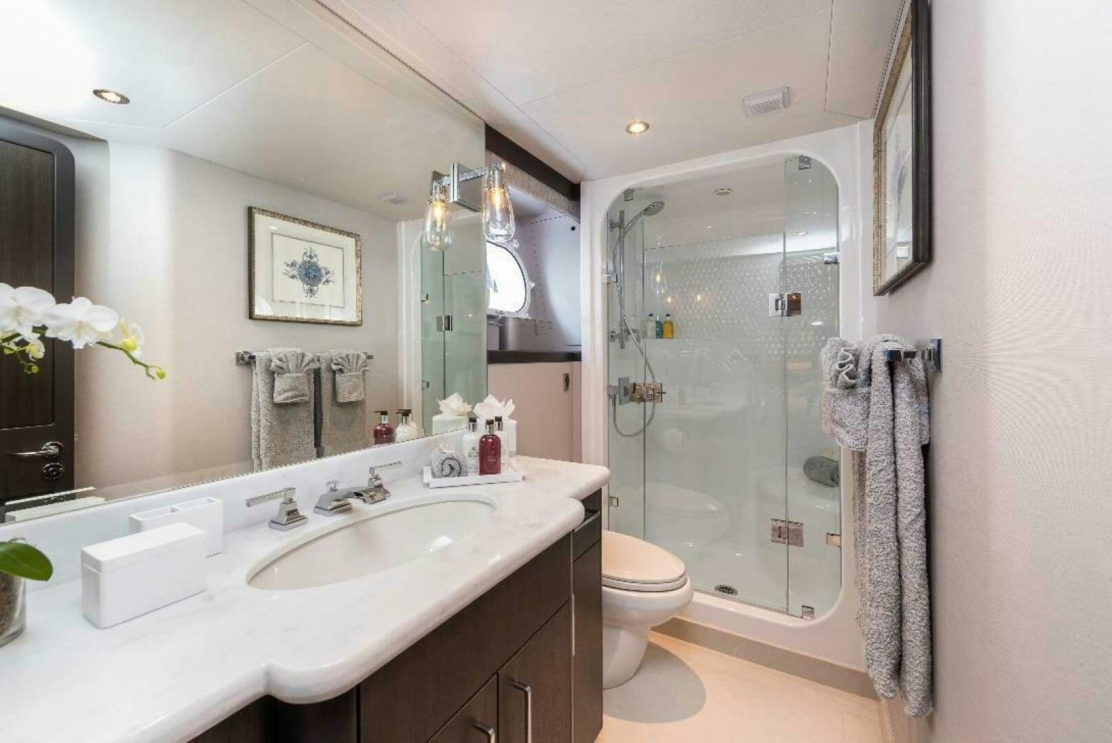 a bathroom with a glass shower aboard MEMENTO VIVERE Yacht for Sale