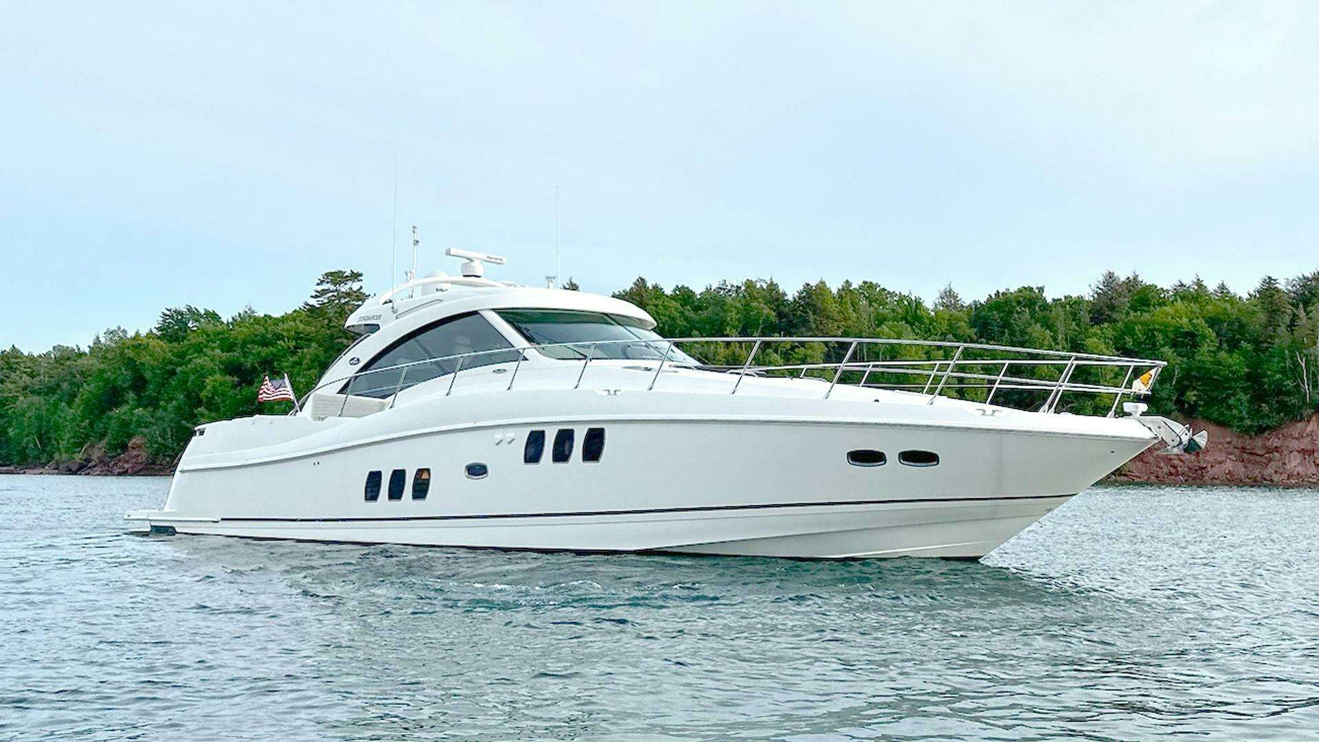 a white yacht on the water aboard THREE SONS Yacht for Sale