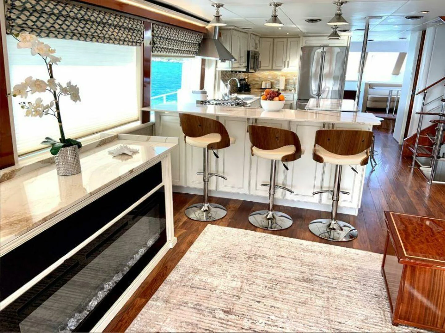 a kitchen with stools and a countertop aboard CHASER - BEING OFFERED ON A 50% PARTNERSHIP BASIS Yacht for Sale