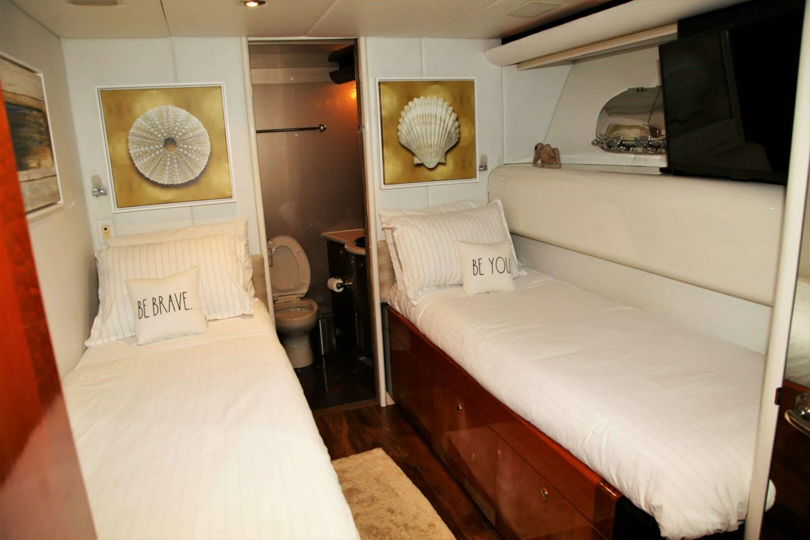 a room with a bed and a television aboard CHASER - BEING OFFERED ON A 50% PARTNERSHIP BASIS Yacht for Sale