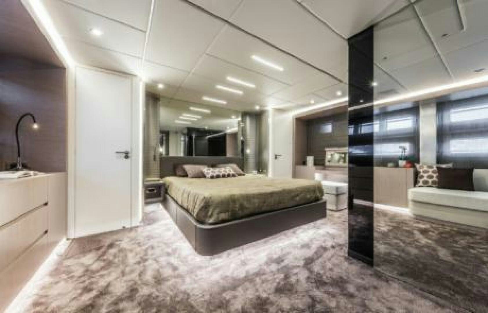 a large room with a bed and a mirror aboard OCEANIC 76' GT Yacht for Sale