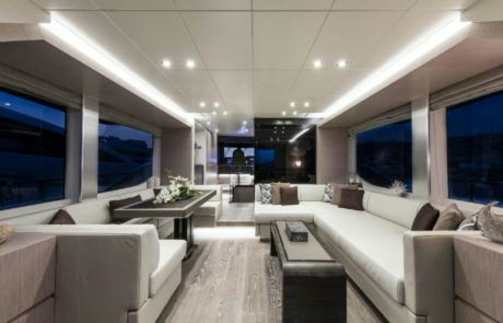 a room with a couch and a table aboard OCEANIC 76' GT Yacht for Sale