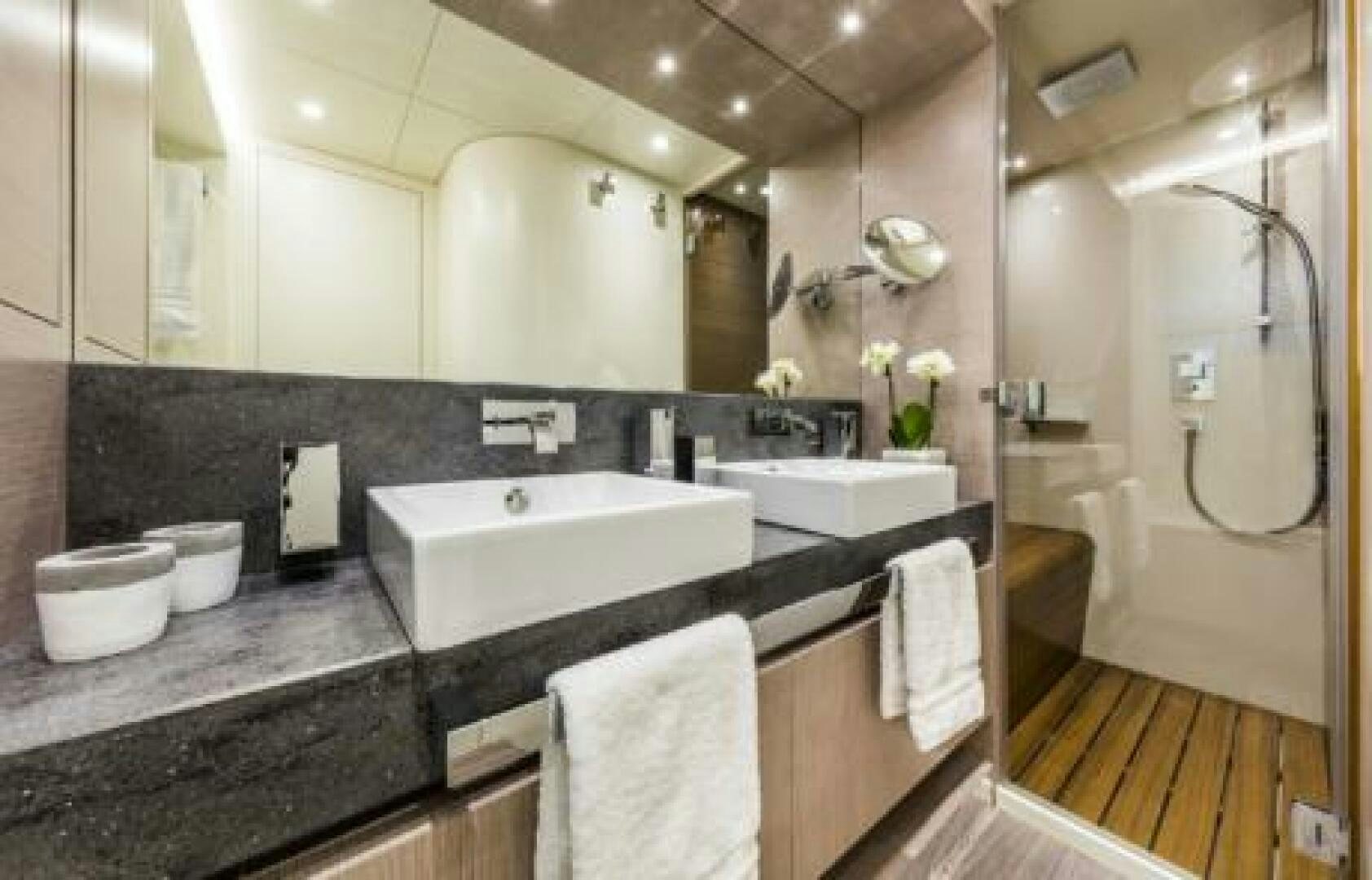 a bathroom with a sink and a mirror aboard OCEANIC 76' GT Yacht for Sale