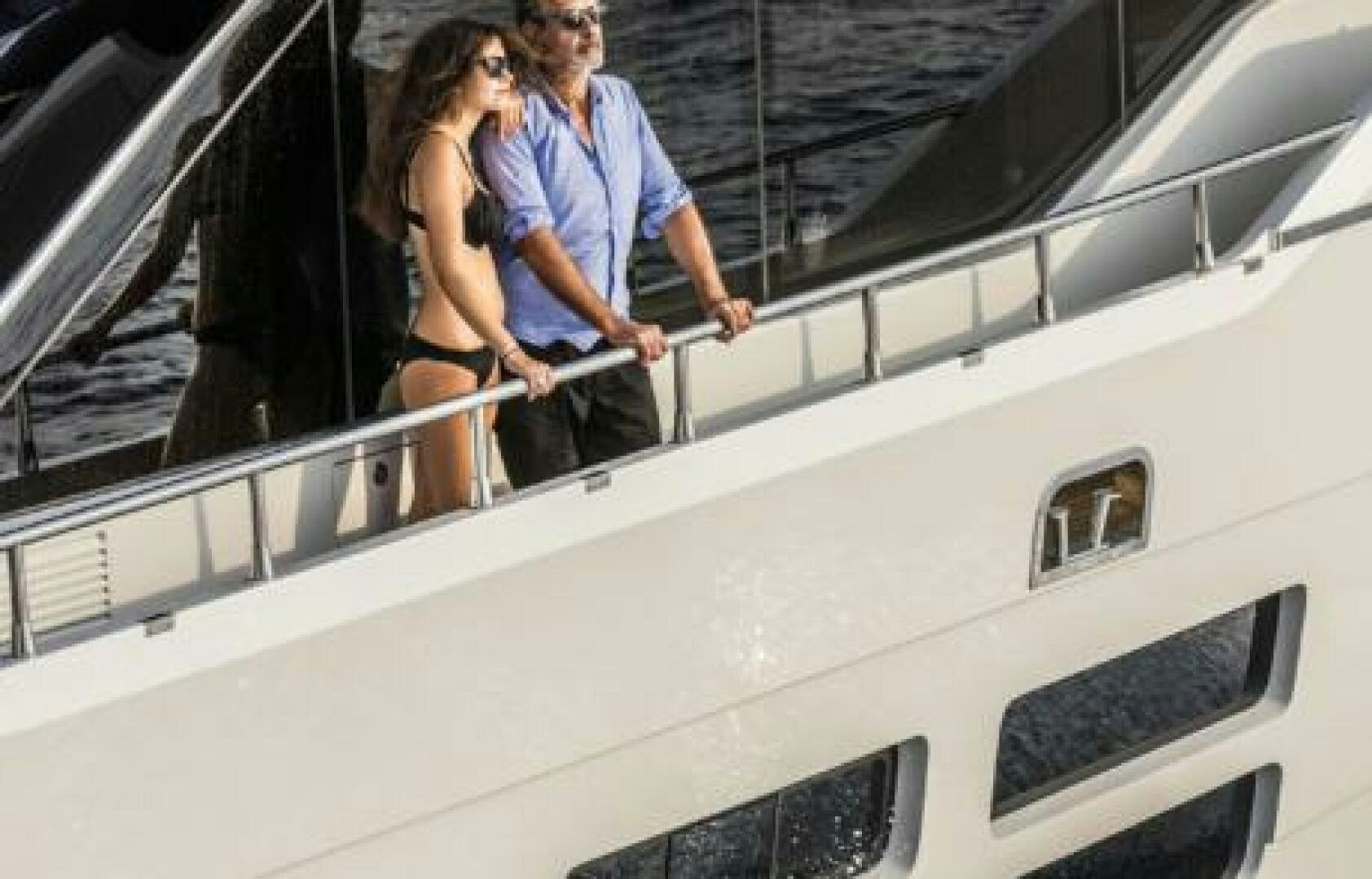 a man and woman on a boat aboard OCEANIC 76' GT Yacht for Sale