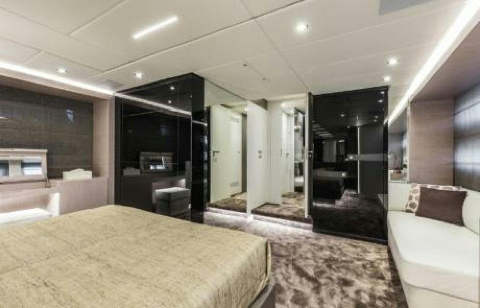 a large bedroom with a bed aboard OCEANIC 76' GT Yacht for Sale