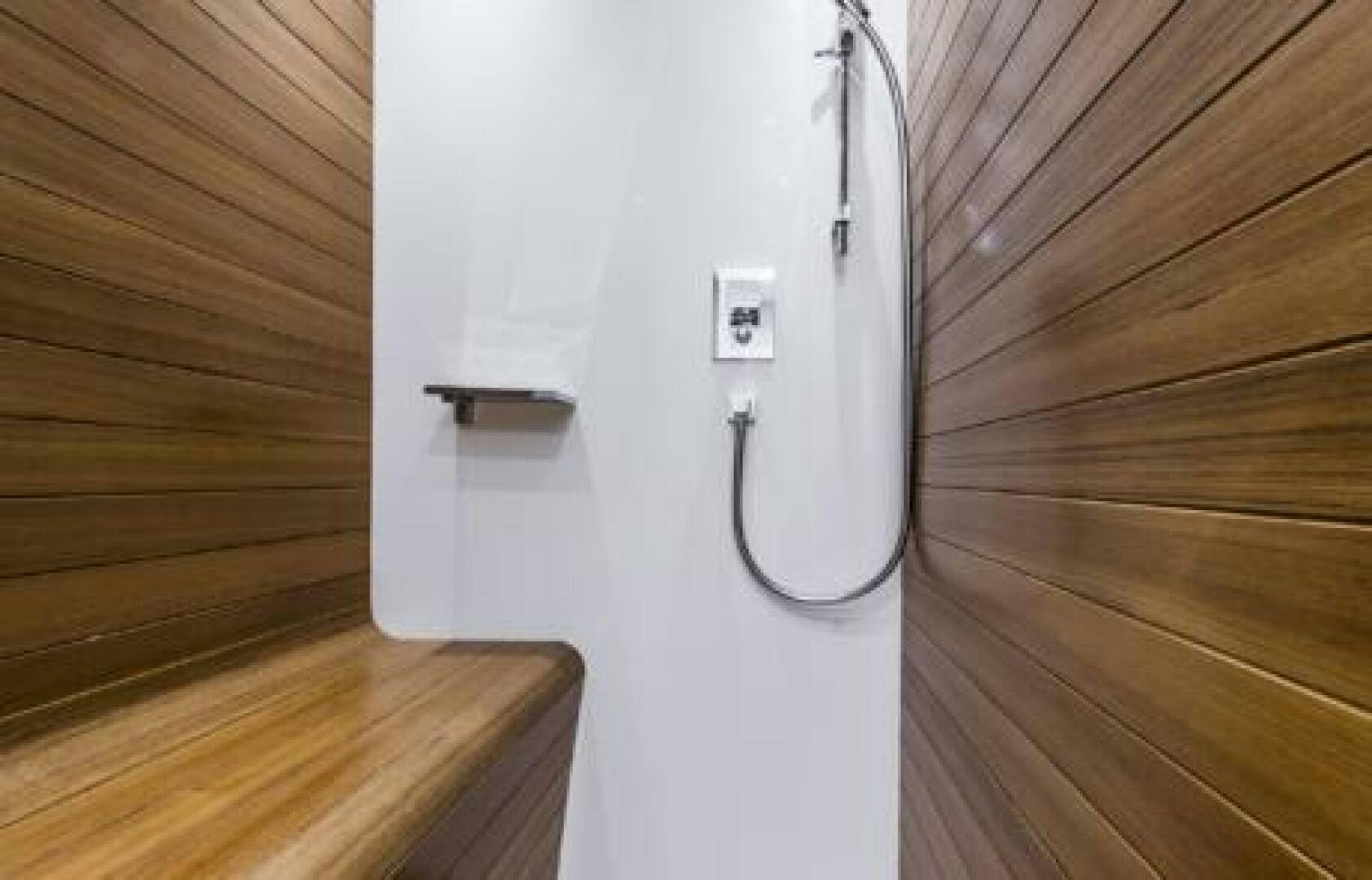 a white electrical outlet on a wooden wall aboard OCEANIC 76' GT Yacht for Sale