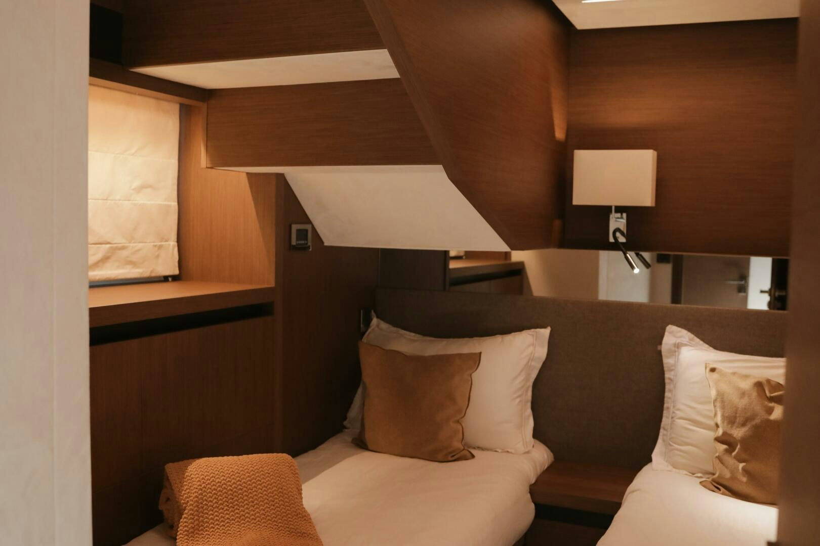a room with a bed and a lamp aboard IL DISFRUTE Yacht for Sale