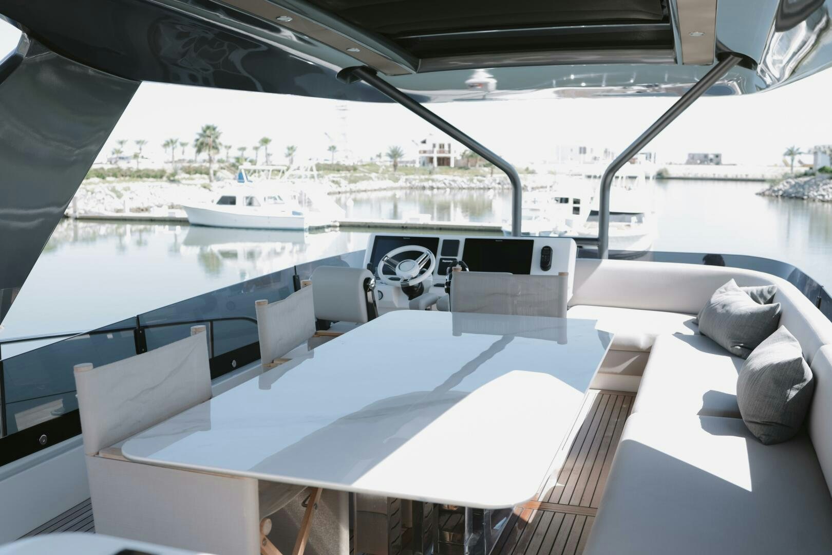 a large white table with chairs on it next to a large window aboard IL DISFRUTE Yacht for Sale