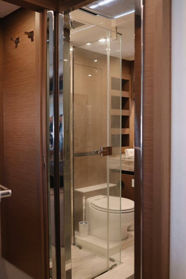 a bathroom with a glass shower aboard IL DISFRUTE Yacht for Sale