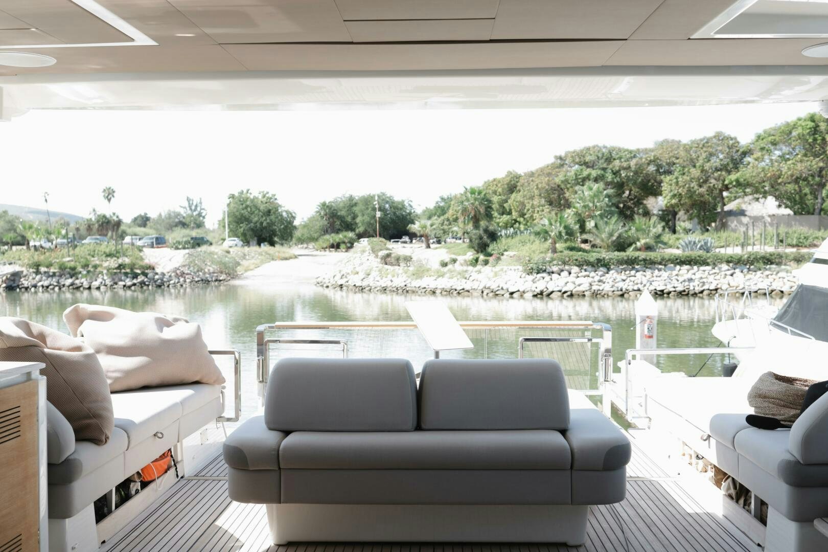 a room with a view of a lake and a large patio with chairs aboard IL DISFRUTE Yacht for Sale
