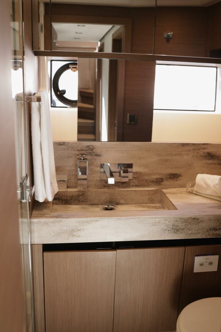 a bathroom with a sink and a mirror aboard IL DISFRUTE Yacht for Sale