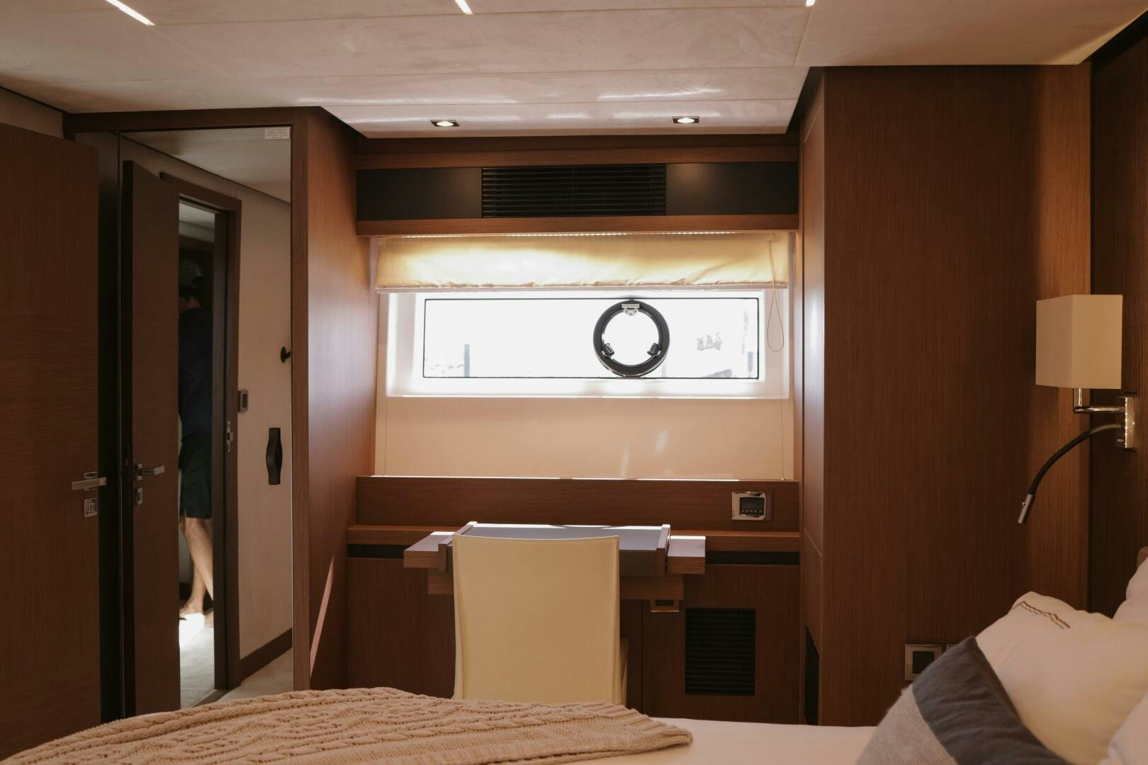 a room with a bed and a desk aboard IL DISFRUTE Yacht for Sale