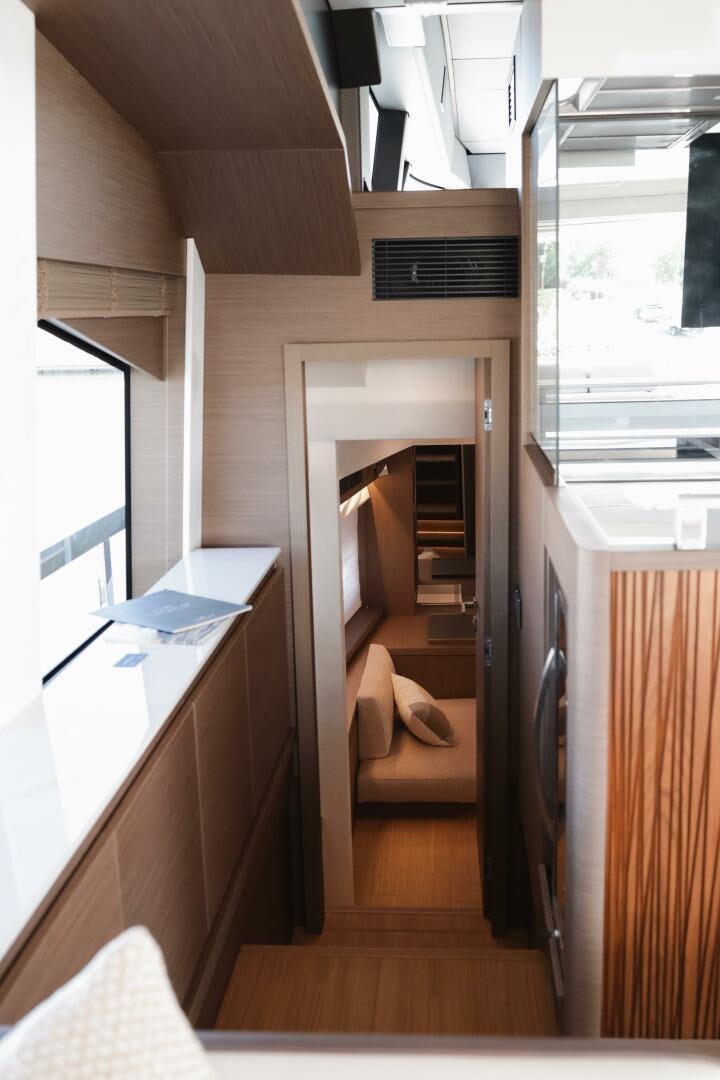 a room with a wood door and a chair aboard IL DISFRUTE Yacht for Sale