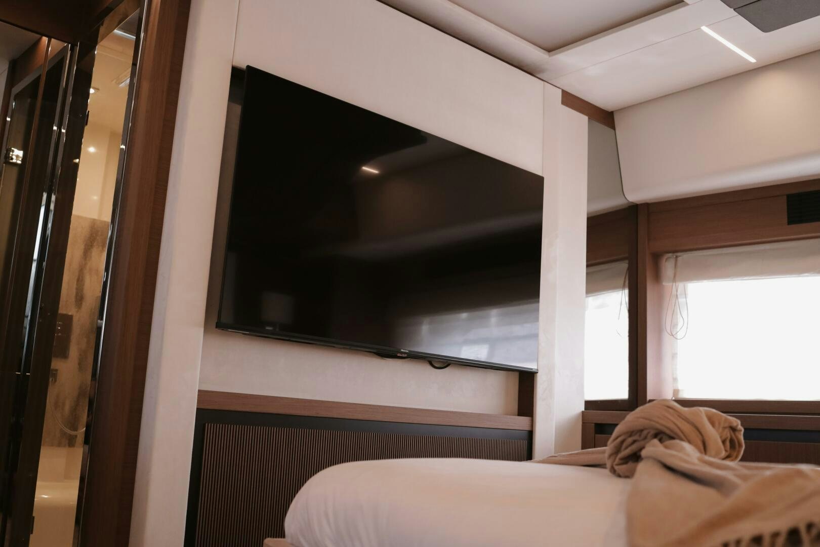 a room with a bed and a window aboard IL DISFRUTE Yacht for Sale