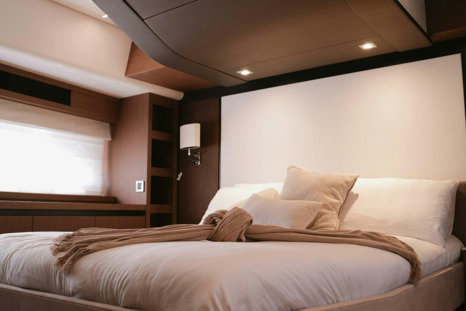 a room with a bed and a lamp aboard IL DISFRUTE Yacht for Sale