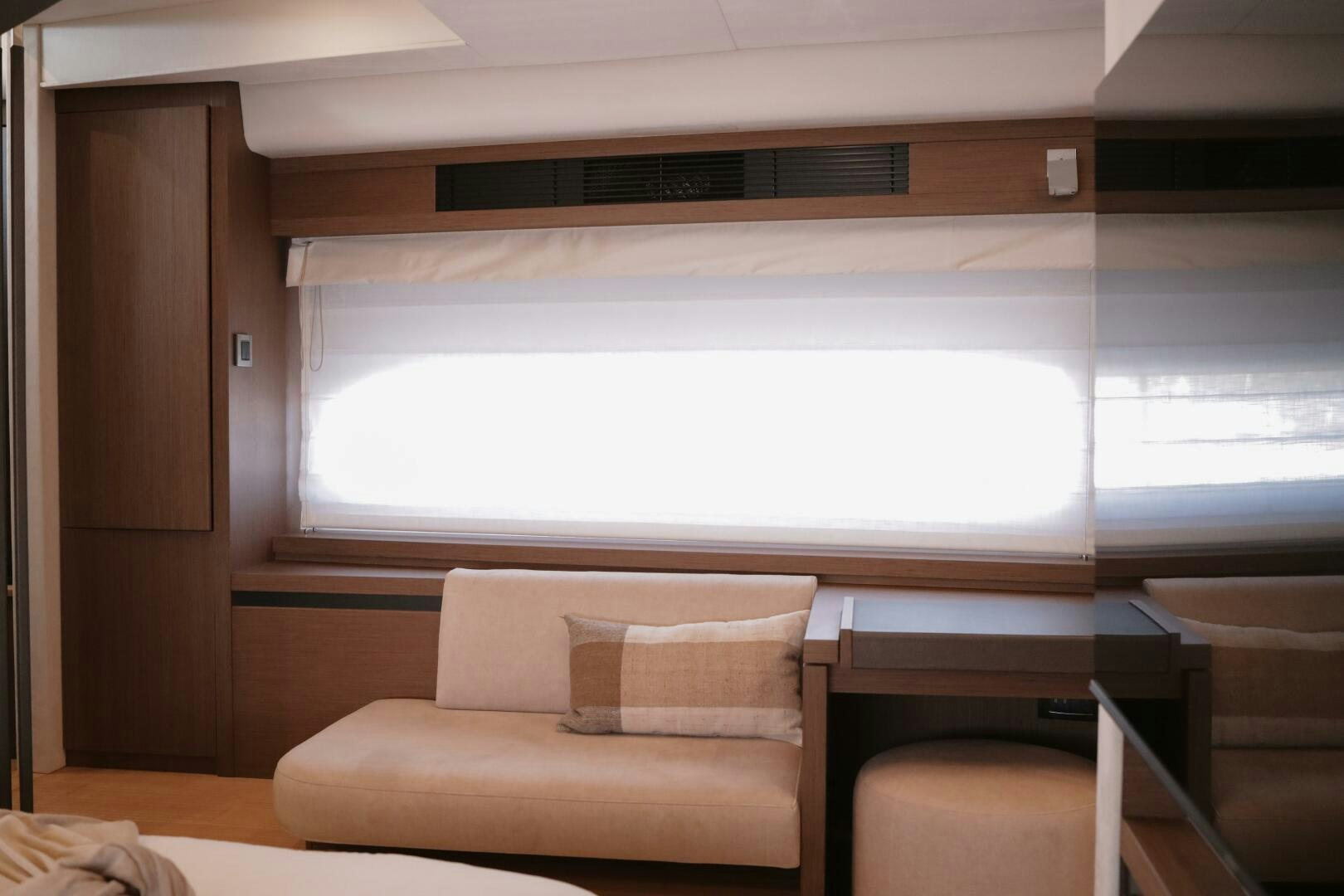 a room with a couch and a window aboard IL DISFRUTE Yacht for Sale