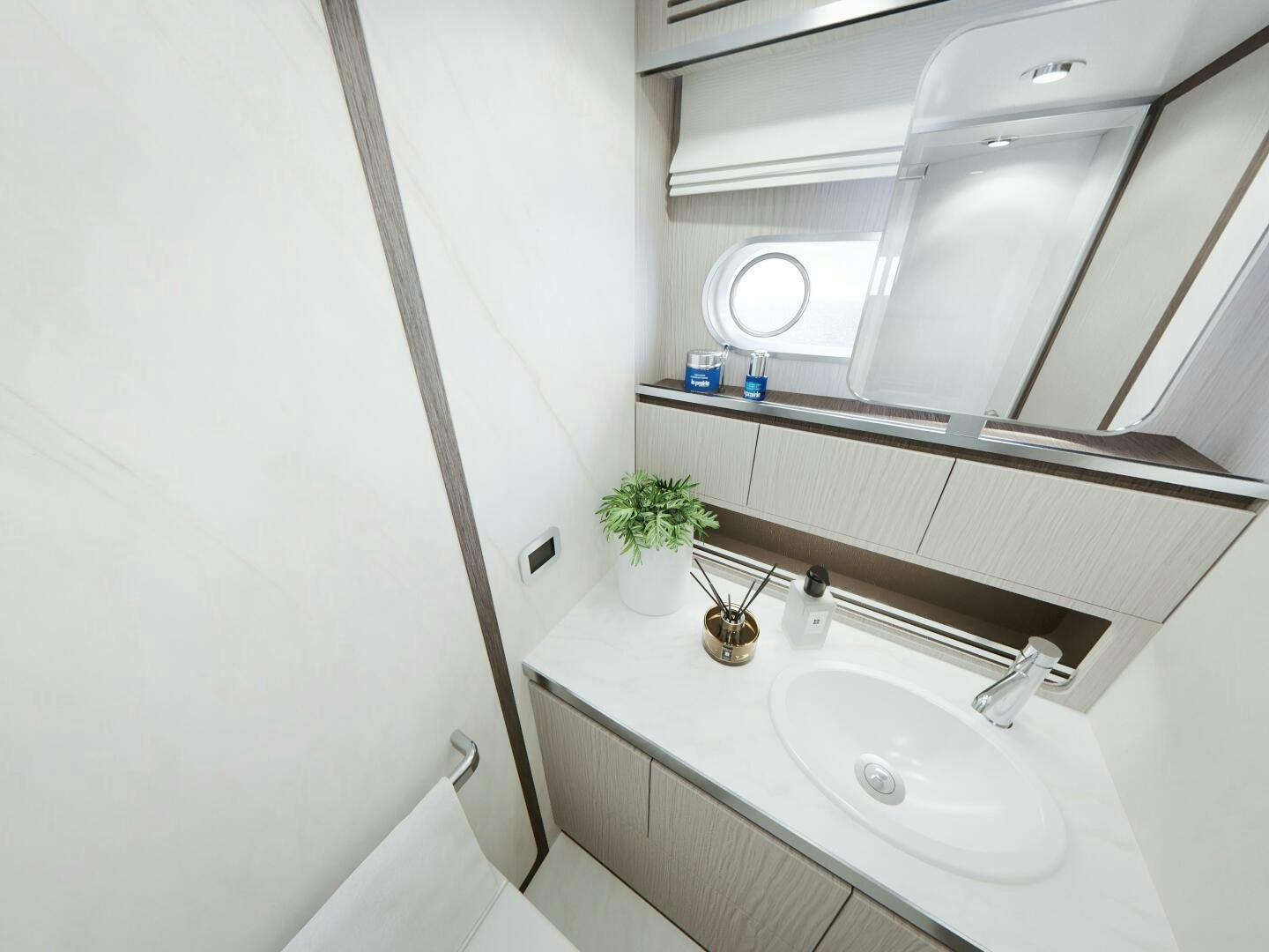 a bathroom with a sink and a shelf with a plant on it aboard CORMORANT Yacht for Sale