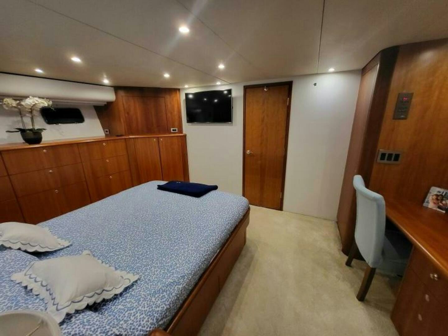 a bedroom with a bed and a desk aboard MAR JON Yacht for Sale